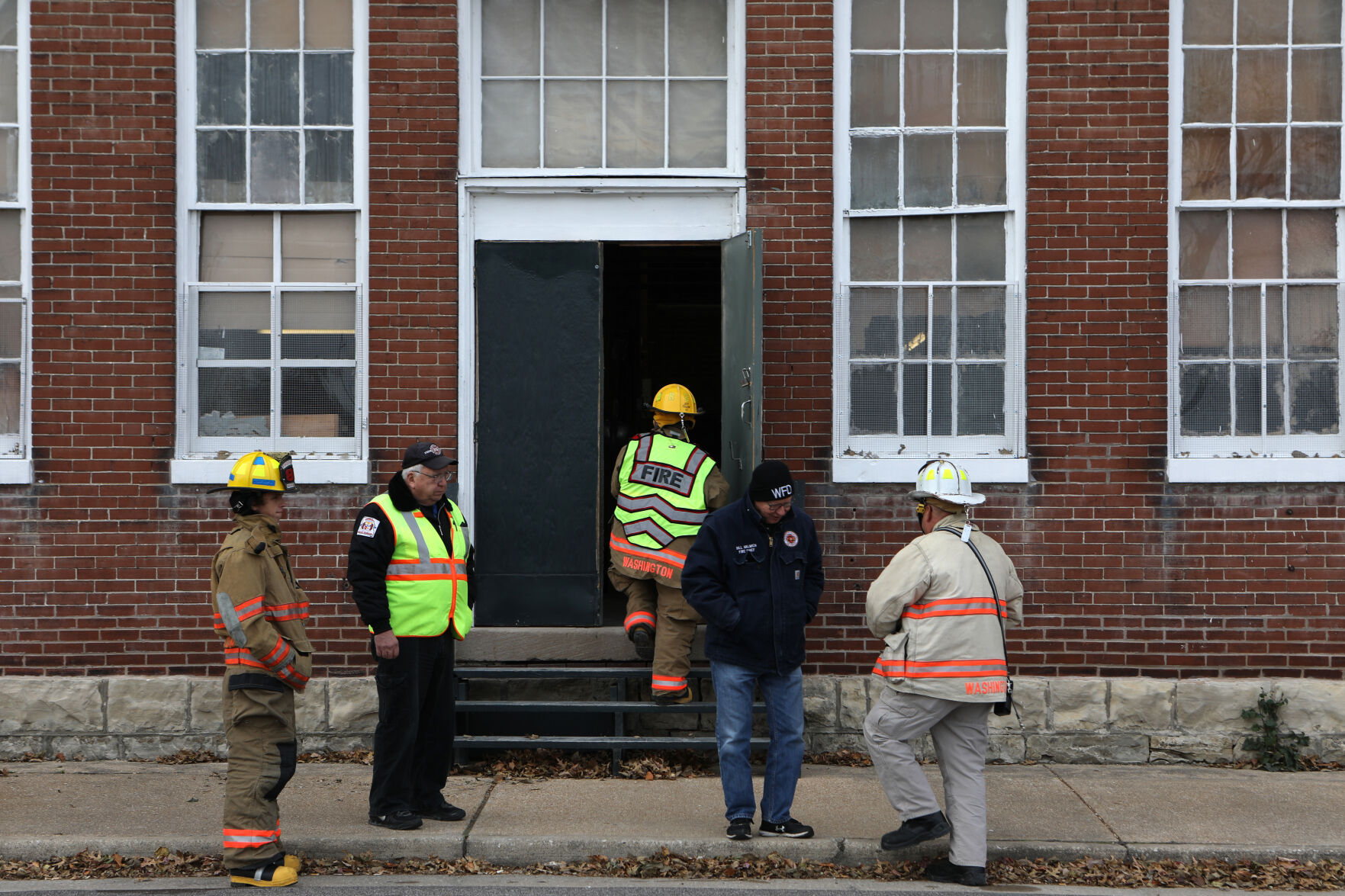 Firefighters gather outside corn cob pipe factory